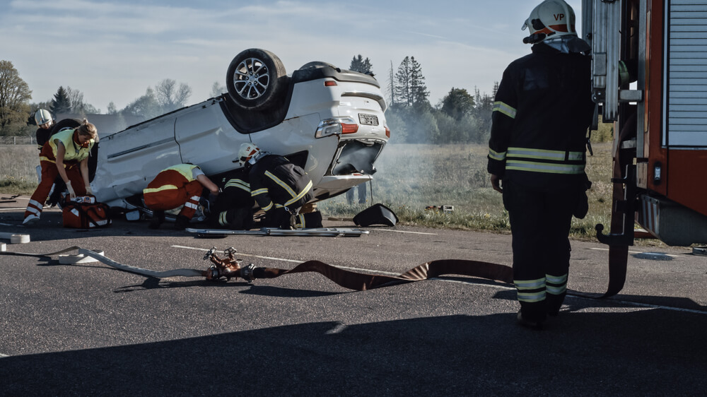 Rescue Team Of Firefighters And Paramedics Work On A Terrible Wreck To Save A Victim