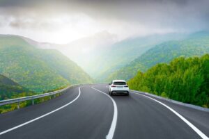 A white car driver on mountain road