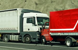 A road accident involving two trucks in a frontal collision.